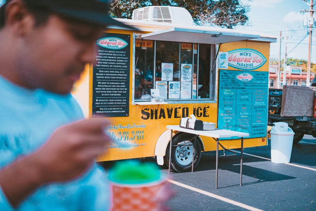 Kona Ice of Hardin Valley/Clinton/Powell Knoxville TN mobile truck with children enjoying colorful shaved ice outdoors.