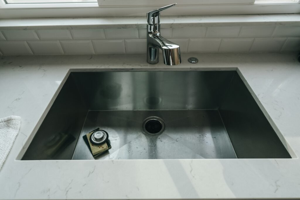 How to Clean Stainless Steel Sink covering DIY cleaning, rust stain removal, water spots, grease cleanup, and finish protection.